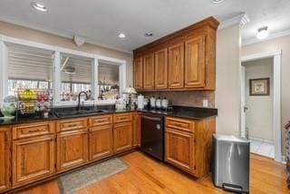 kitchen with dark countertops, dishwasher, and brown cabinetry