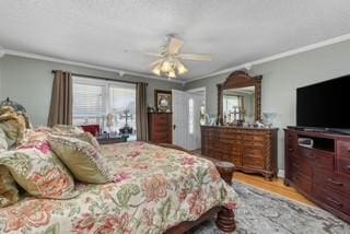 bedroom featuring crown molding, wood finished floors, and ceiling fan