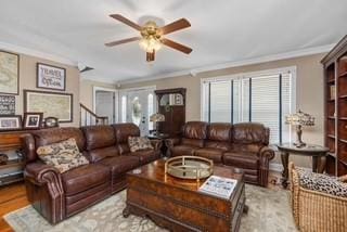 living area featuring wood finished floors, a healthy amount of sunlight, ceiling fan, and crown molding