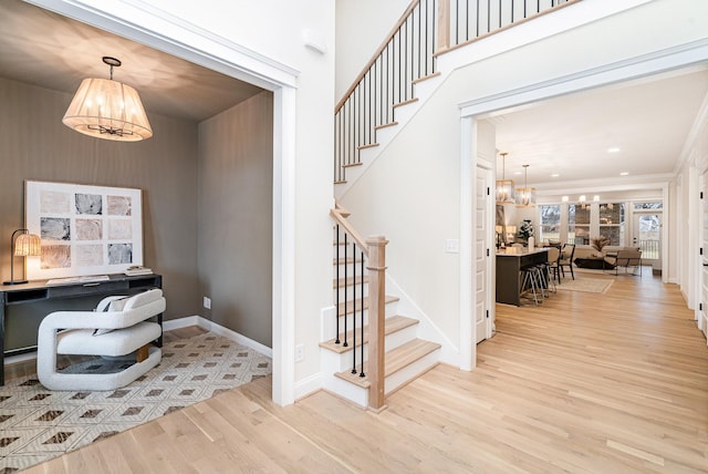 office space with an inviting chandelier, recessed lighting, baseboards, and light wood-type flooring