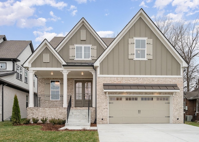 view of front of property featuring brick siding, board and batten siding, driveway, and a garage