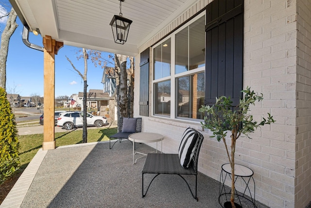 view of patio / terrace with a residential view and covered porch