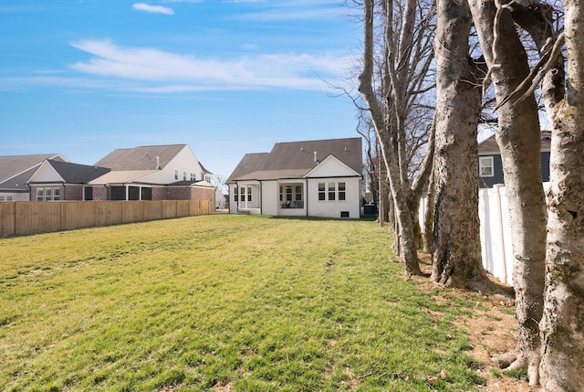 back of house with a yard and fence