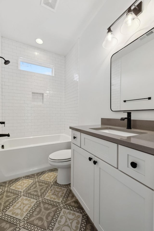 full bathroom with tile patterned flooring, visible vents, toilet, shower / bathing tub combination, and vanity