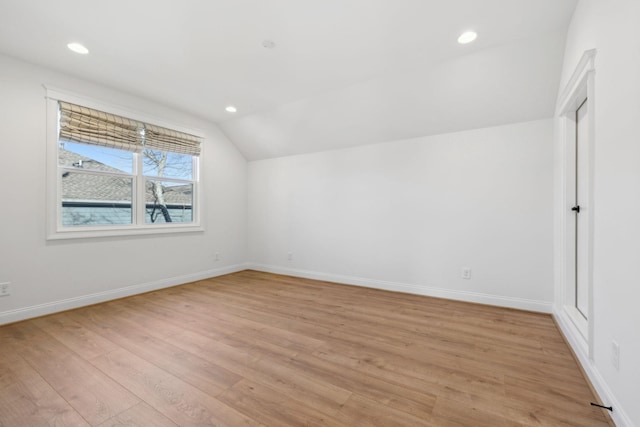 bonus room with recessed lighting, light wood-type flooring, baseboards, and vaulted ceiling