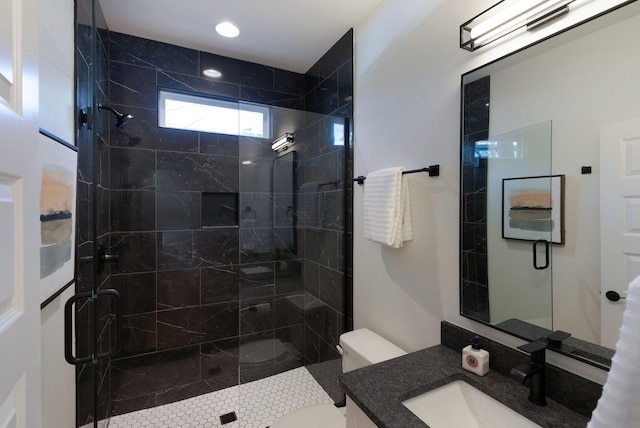 bathroom featuring vanity, toilet, and a stall shower