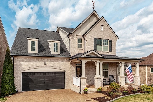 craftsman inspired home featuring brick siding, covered porch, and driveway