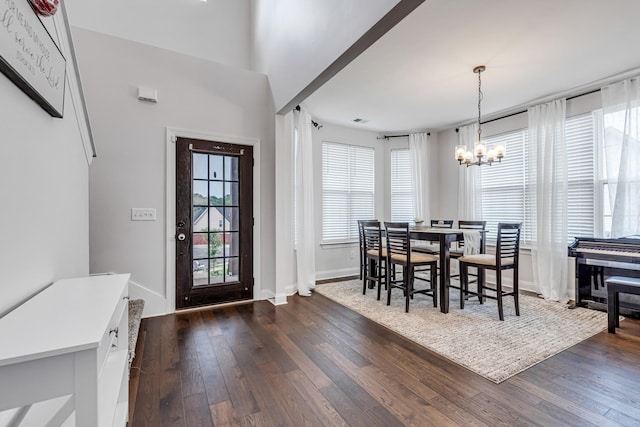 dining area with visible vents, dark wood-style floors, baseboards, and a chandelier