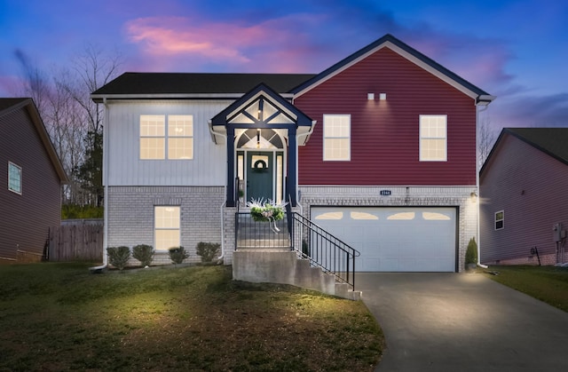 view of front facade featuring brick siding, driveway, an attached garage, and fence