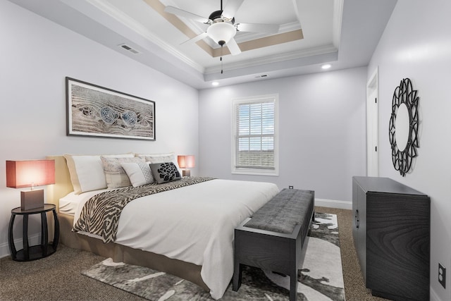 carpeted bedroom featuring visible vents, a raised ceiling, ornamental molding, baseboards, and ceiling fan