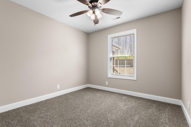 spare room with a ceiling fan, carpet, visible vents, and baseboards