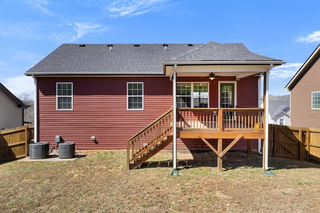 back of property with central AC unit, ceiling fan, a shingled roof, and a fenced backyard