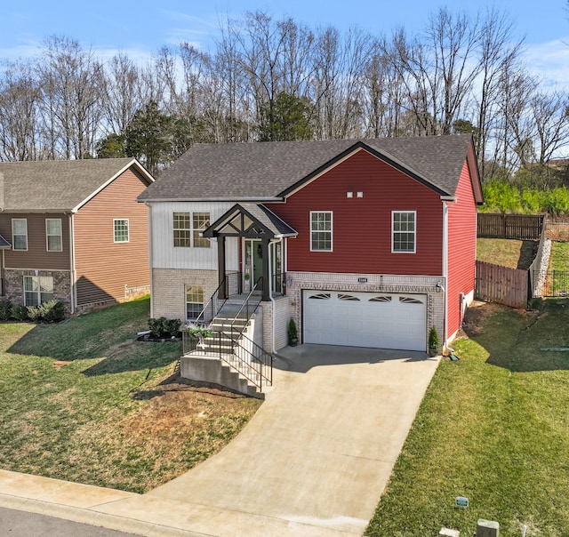 raised ranch with a garage, brick siding, concrete driveway, and a front lawn