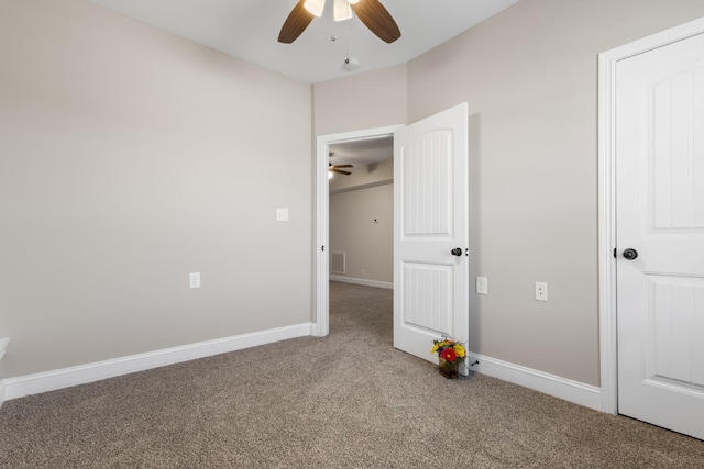 unfurnished bedroom featuring visible vents, carpet floors, baseboards, and a ceiling fan