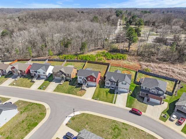 birds eye view of property featuring a view of trees and a residential view