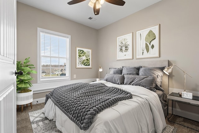 carpeted bedroom featuring visible vents, baseboards, and a ceiling fan