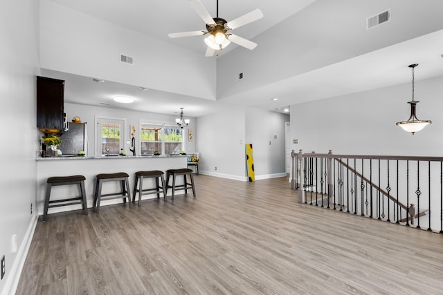 interior space with visible vents, baseboards, wood finished floors, and freestanding refrigerator