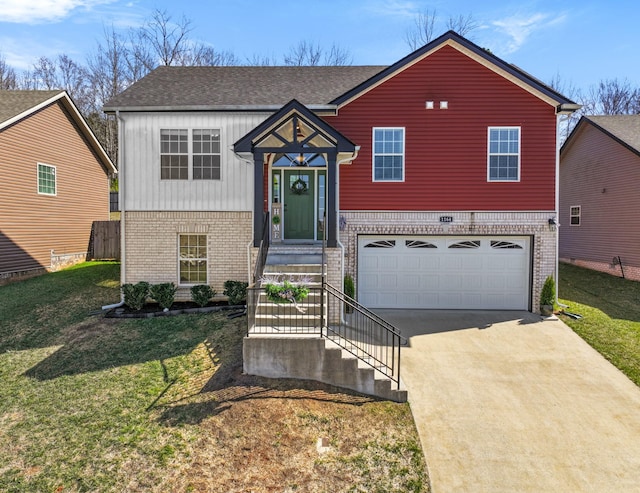 bi-level home with brick siding, driveway, an attached garage, and a front lawn