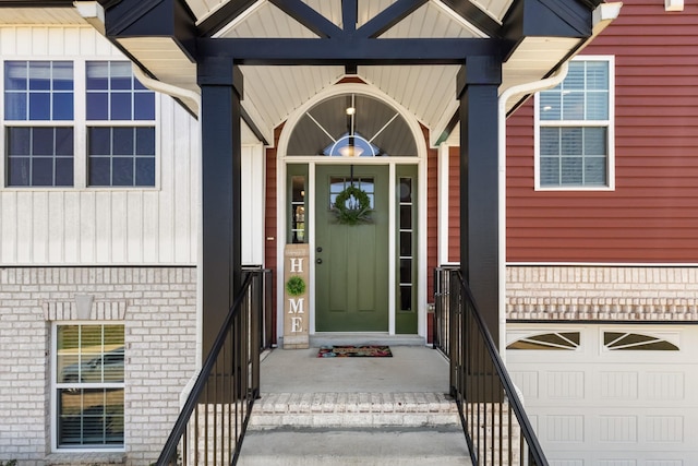 property entrance with brick siding and a garage