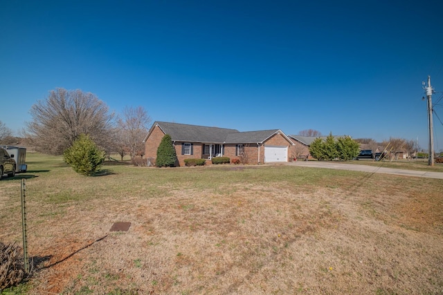 single story home with a front yard, brick siding, a garage, and driveway