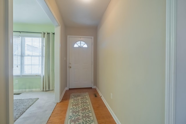 entryway with light wood-style flooring and baseboards