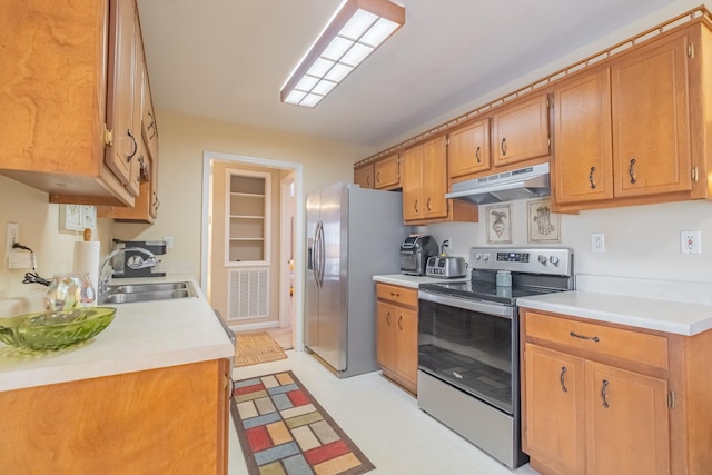 kitchen featuring under cabinet range hood, stainless steel appliances, visible vents, and light countertops