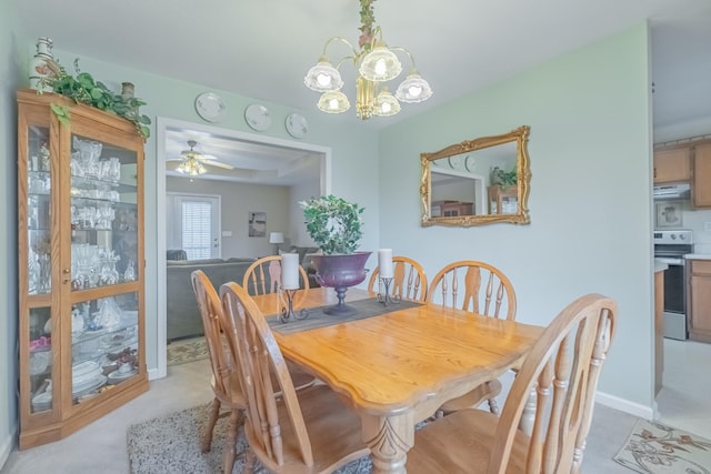 dining room with baseboards and ceiling fan with notable chandelier