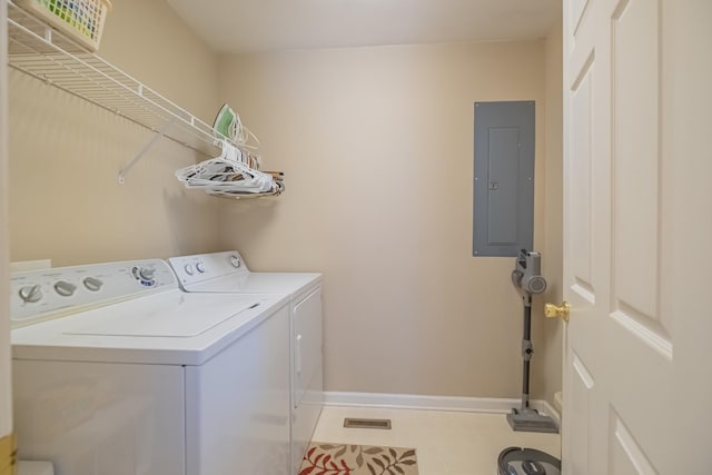 clothes washing area featuring electric panel, laundry area, washer and clothes dryer, and baseboards