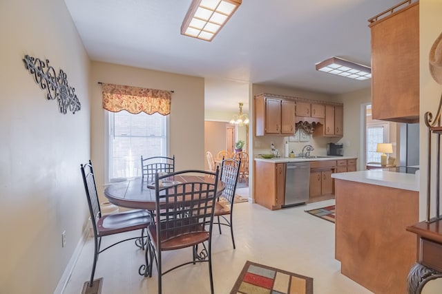 kitchen with visible vents, baseboards, light countertops, stainless steel dishwasher, and a sink