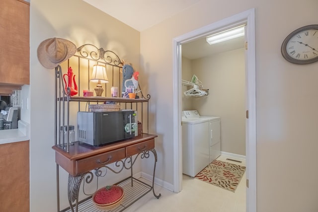 laundry room with laundry area, baseboards, and separate washer and dryer