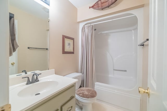 bathroom featuring vanity, toilet, and shower / bath combo with shower curtain