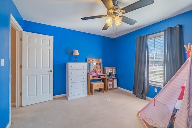 bedroom with ceiling fan, baseboards, and carpet