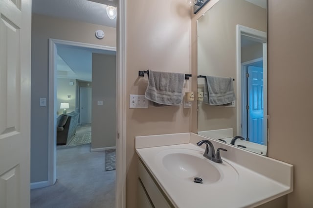 bathroom with vanity and baseboards