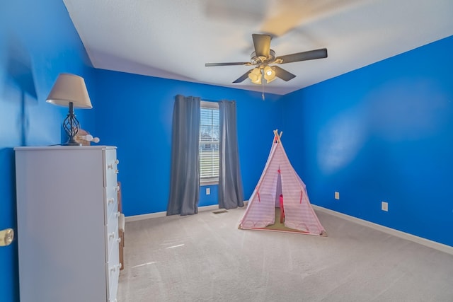 rec room featuring visible vents, baseboards, carpet, and ceiling fan