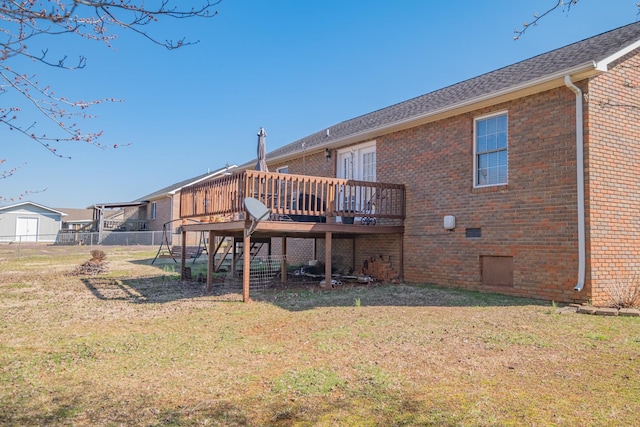 back of house with fence, a wooden deck, a yard, crawl space, and brick siding