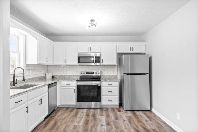 3441 Foxrun Ln, Clarksville, TN 37042 - kitchen featuring white cabinets, appliances with stainless steel finishes, and a sink