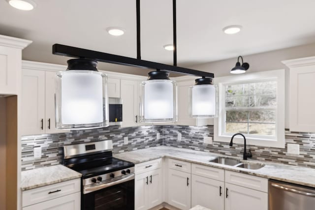 1507 New Harmony Rd, Hartsville, TN 37074 - kitchen with appliances with stainless steel finishes, a sink, white cabinets, and backsplash