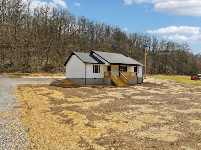 view of front of house featuring a porch, roof with shingles, and crawl space