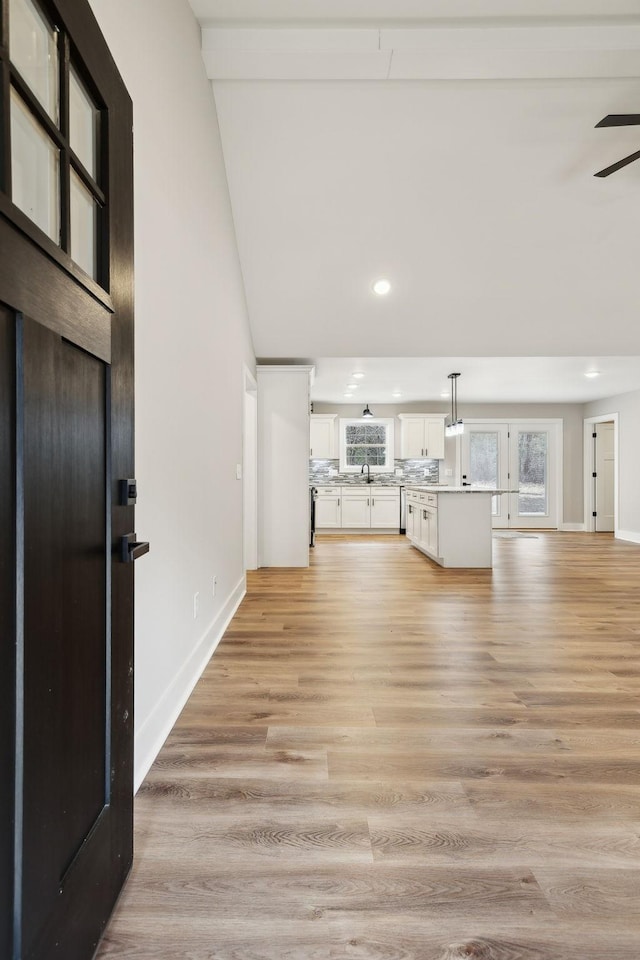 1507 New Harmony Rd, Hartsville, TN 37074 - unfurnished living room with recessed lighting, light wood-type flooring, baseboards, a sink, and ceiling fan