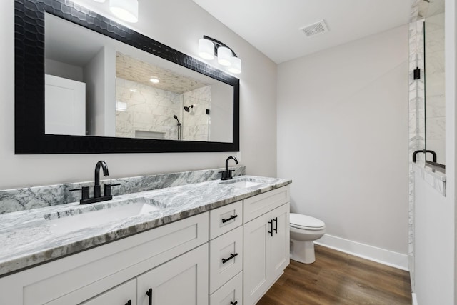 1507 New Harmony Rd, Hartsville, TN 37074 - full bath with toilet, a tile shower, double vanity, baseboards, and wood finished floors