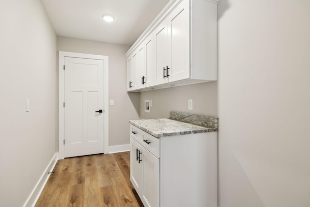 1507 New Harmony Rd, Hartsville, TN 37074 - laundry area with cabinet space, washer hookup, light wood-type flooring, and baseboards