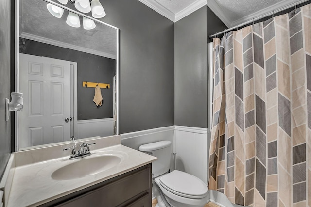 bathroom with wainscoting, a textured ceiling, vanity, and ornamental molding