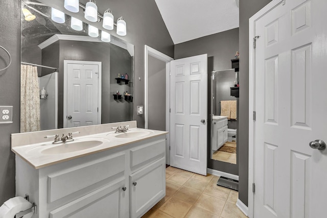 bathroom featuring tile patterned flooring, curtained shower, double vanity, and a sink