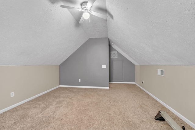 bonus room featuring visible vents, a textured ceiling, carpet, and baseboards