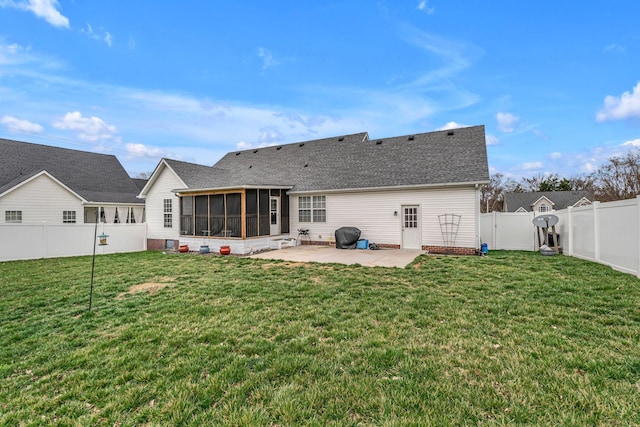 back of property with a patio, a lawn, a fenced backyard, and a sunroom