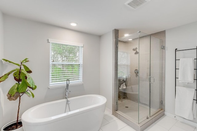 full bathroom with a freestanding tub, visible vents, a stall shower, and tile patterned flooring