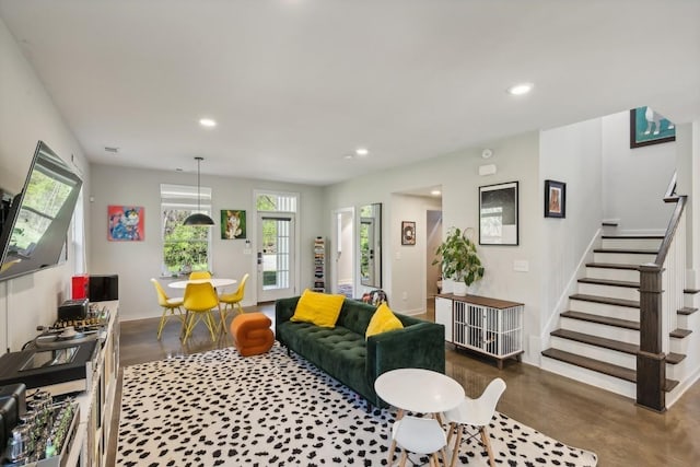 living area featuring stairway, recessed lighting, concrete flooring, and baseboards