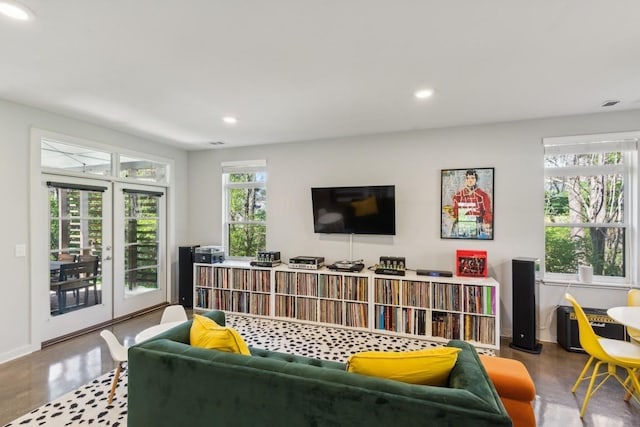 living room featuring recessed lighting, french doors, and concrete floors