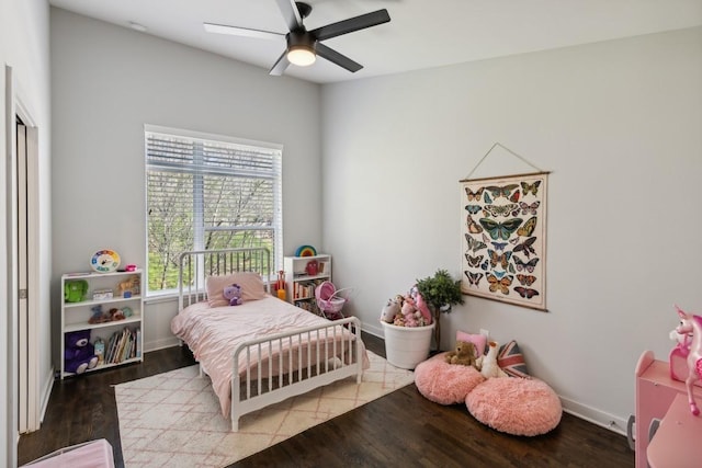 bedroom featuring ceiling fan, baseboards, and wood finished floors