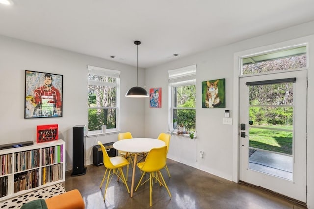 dining space featuring finished concrete flooring